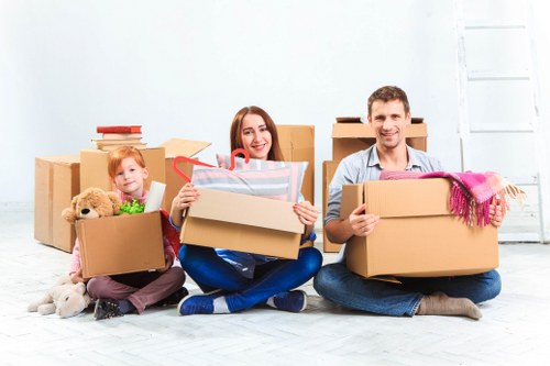 Packed household boxes and furniture ready for transport in Hanworth